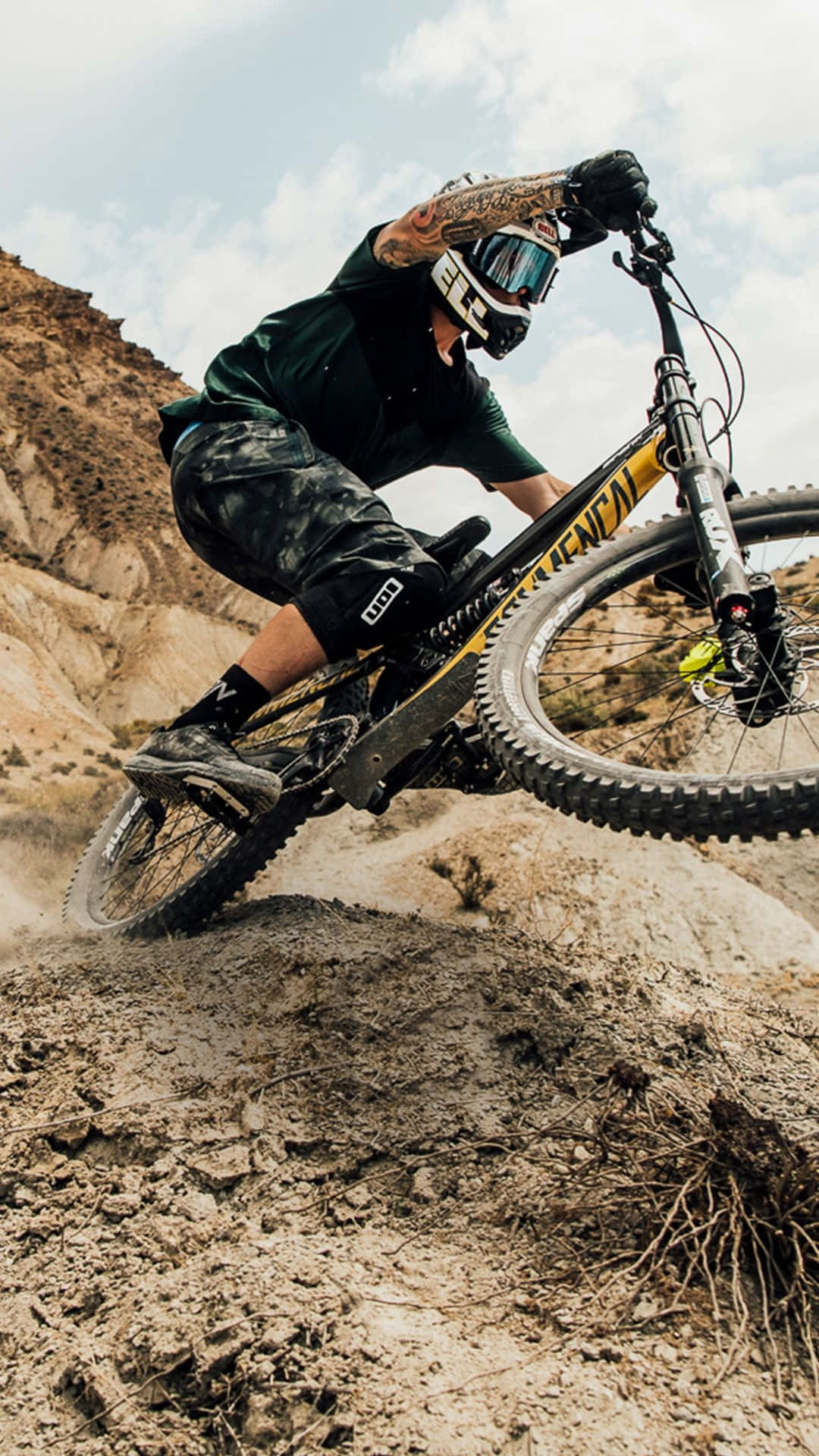 A Man Riding A Mountain Bike In The Desert