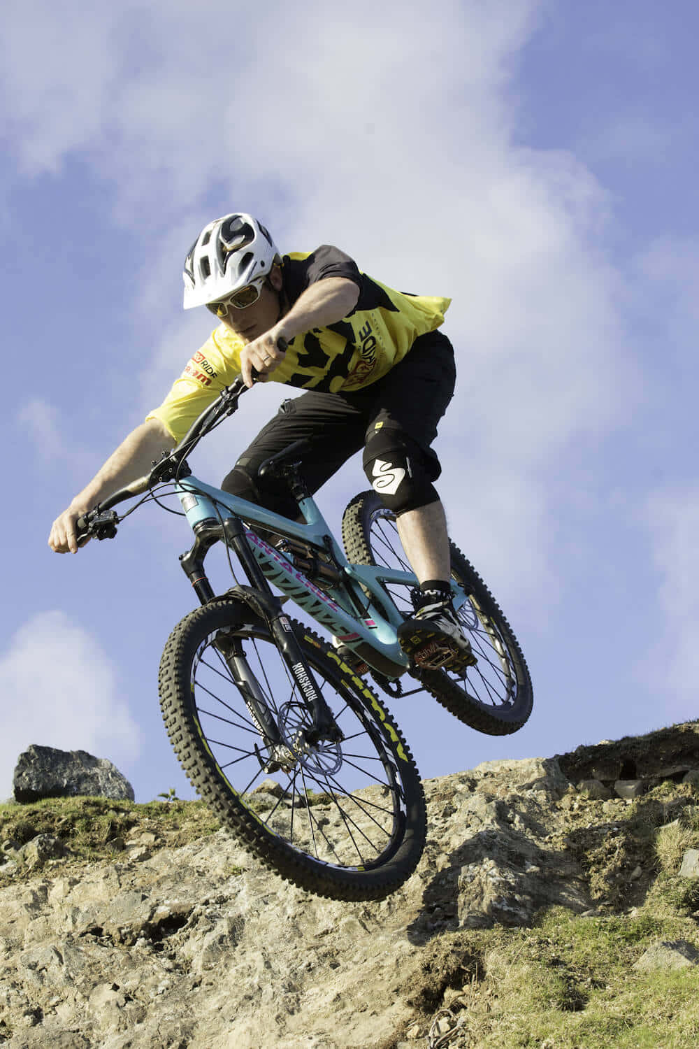 A Man Riding A Mountain Bike Background