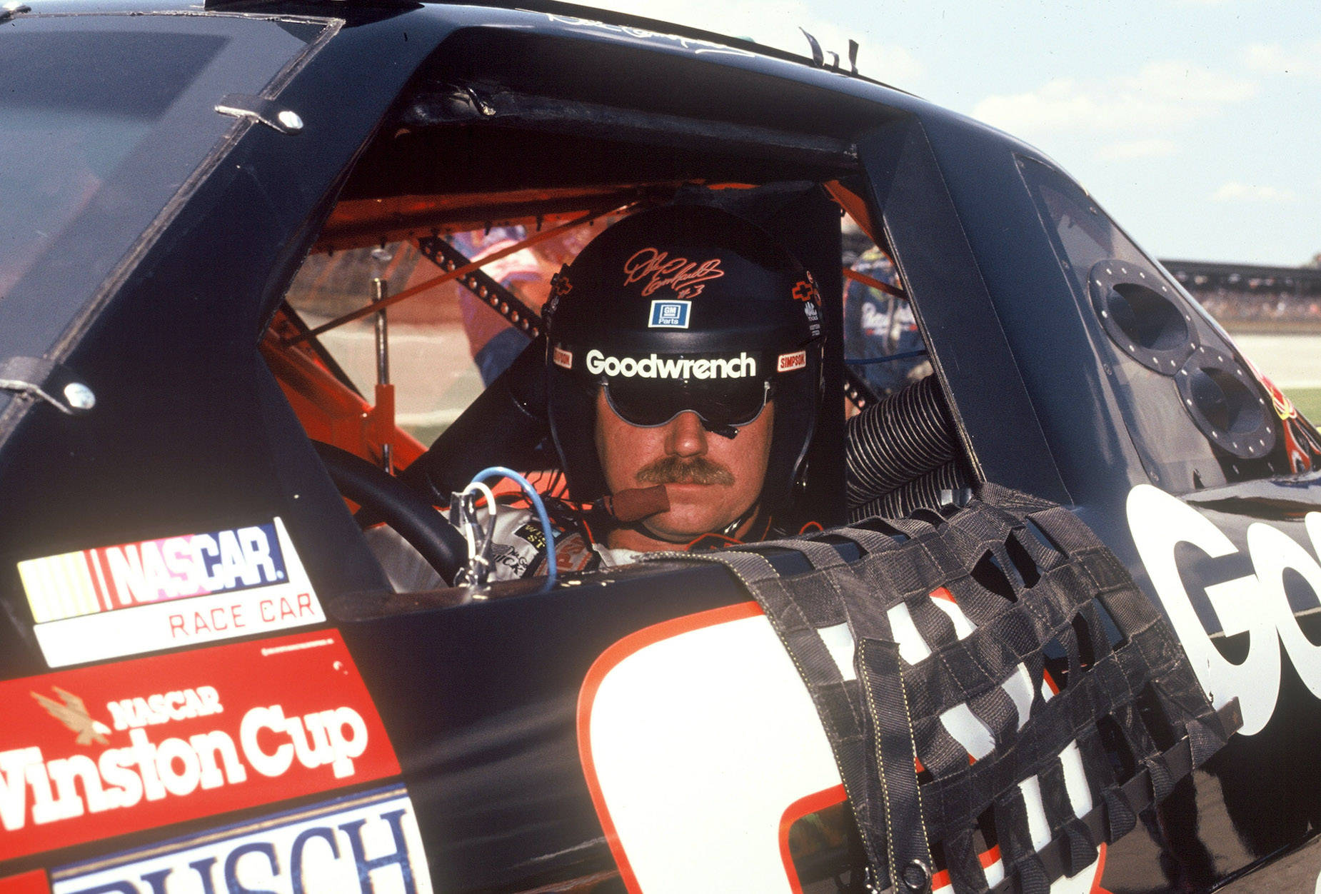 A Man Sitting In A Car