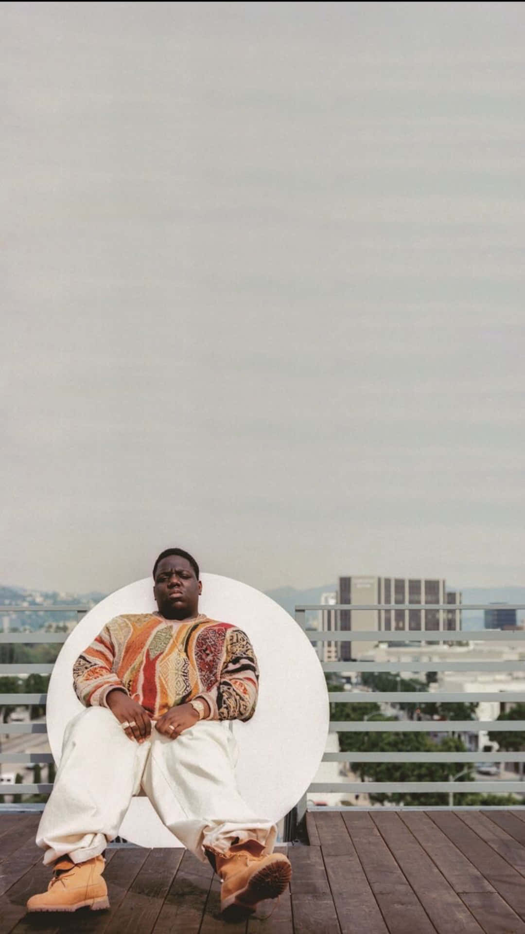 A Man Sitting On A Chair Background