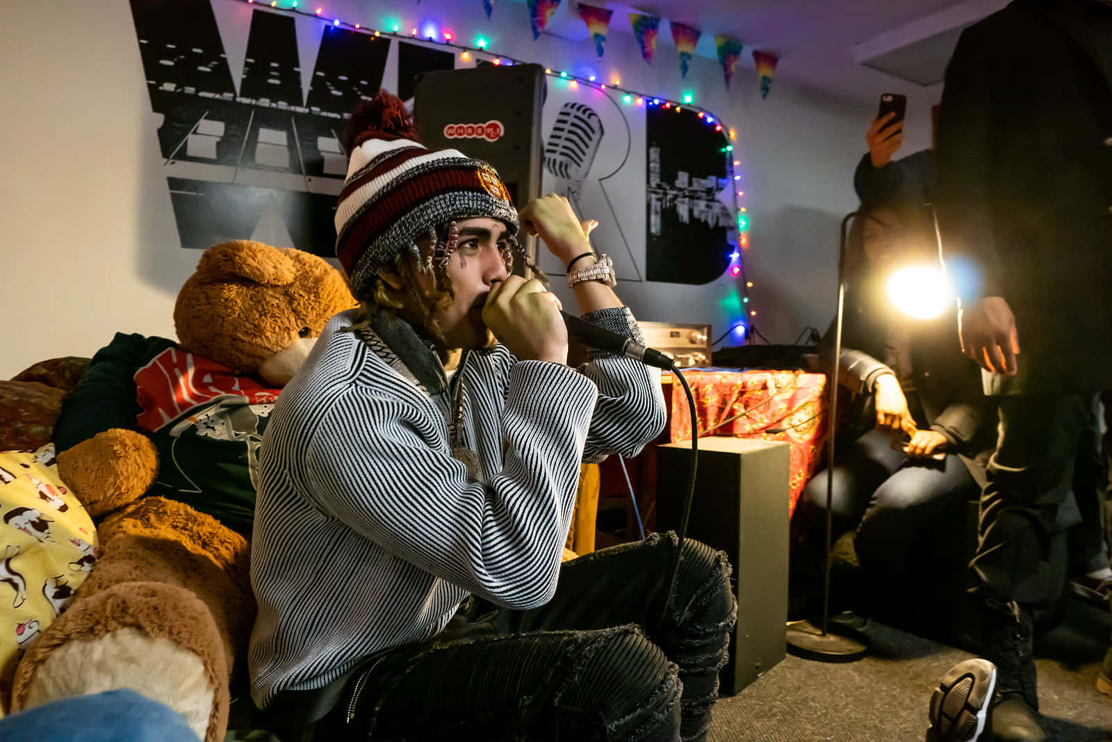 A Man Sitting On A Couch With A Teddy Bear