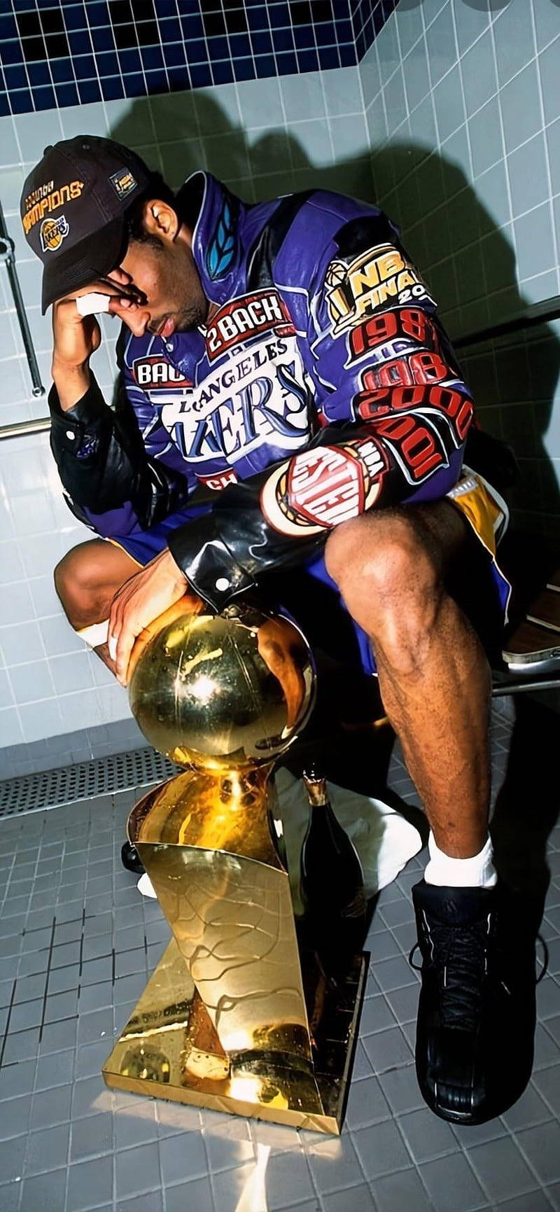 A Man Sitting On A Toilet With A Trophy Background