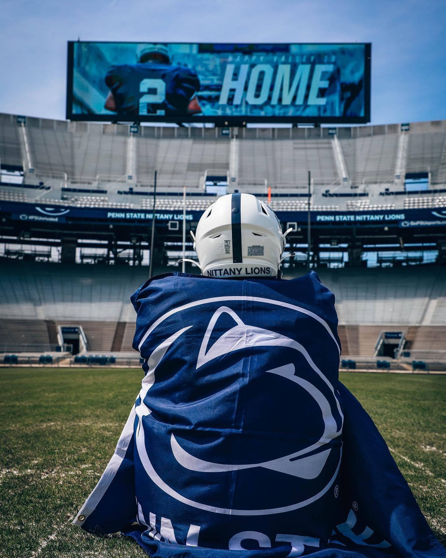 A Man Sitting On The Field With A Blanket