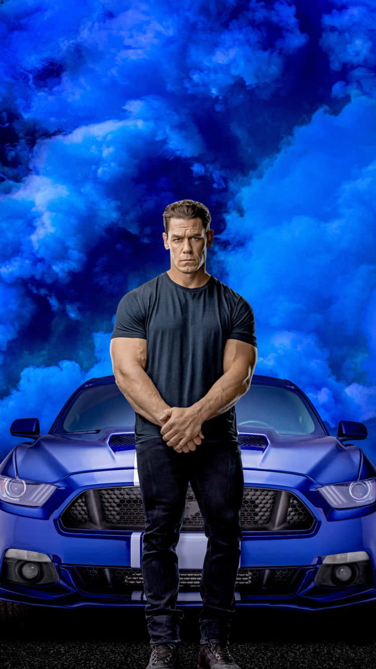 A Man Standing Next To A Blue Car With Clouds In The Background Background