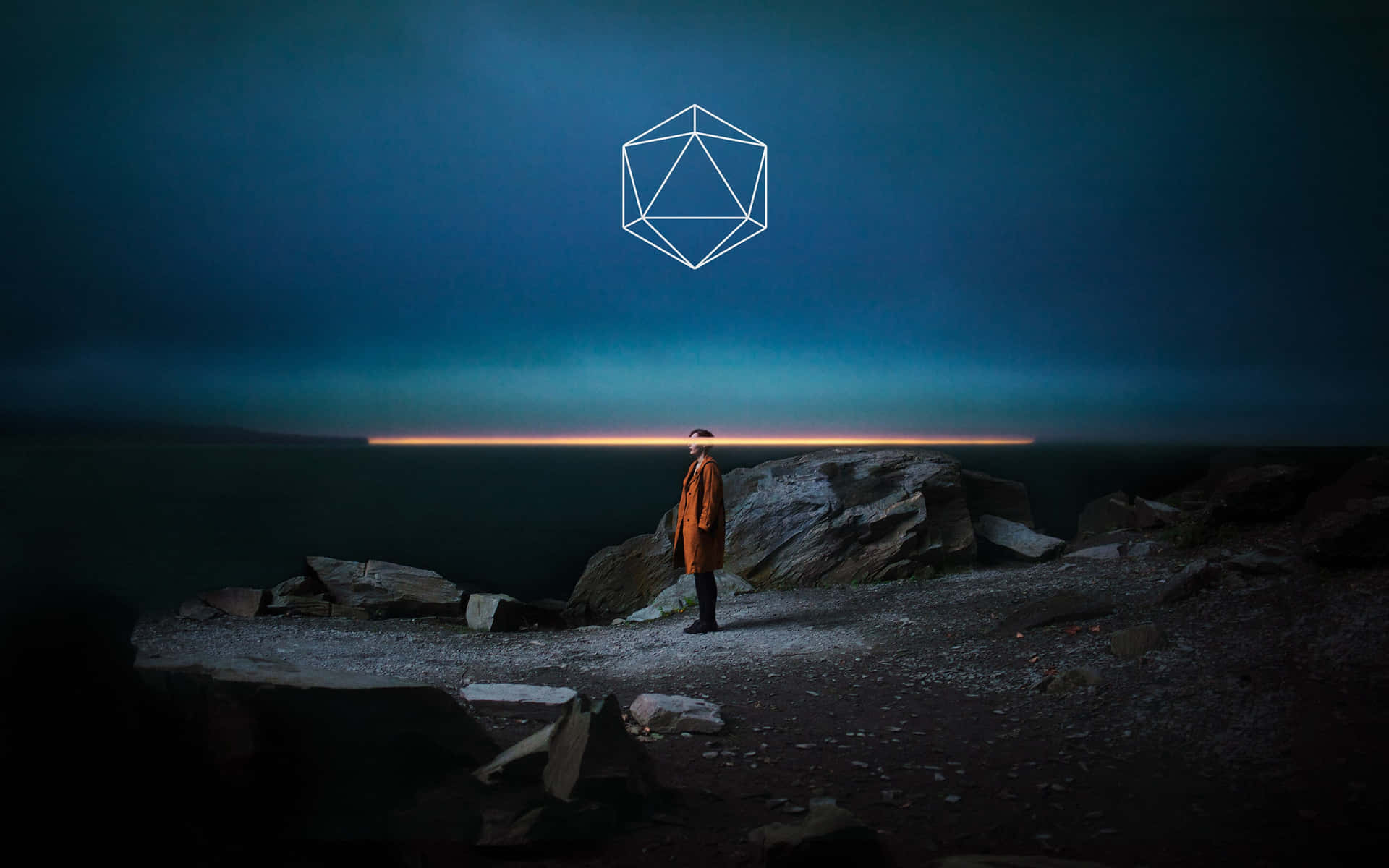 A Man Standing On Rocks At Night With A Geometric Shape In The Sky