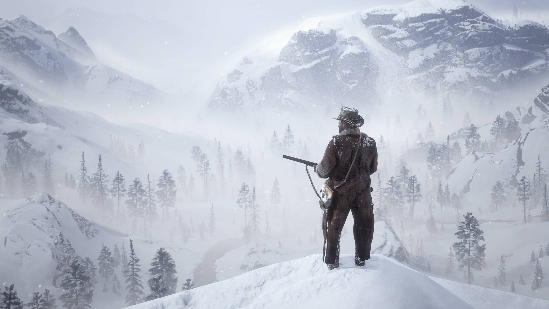 A Man Standing On Top Of A Snowy Mountain Background