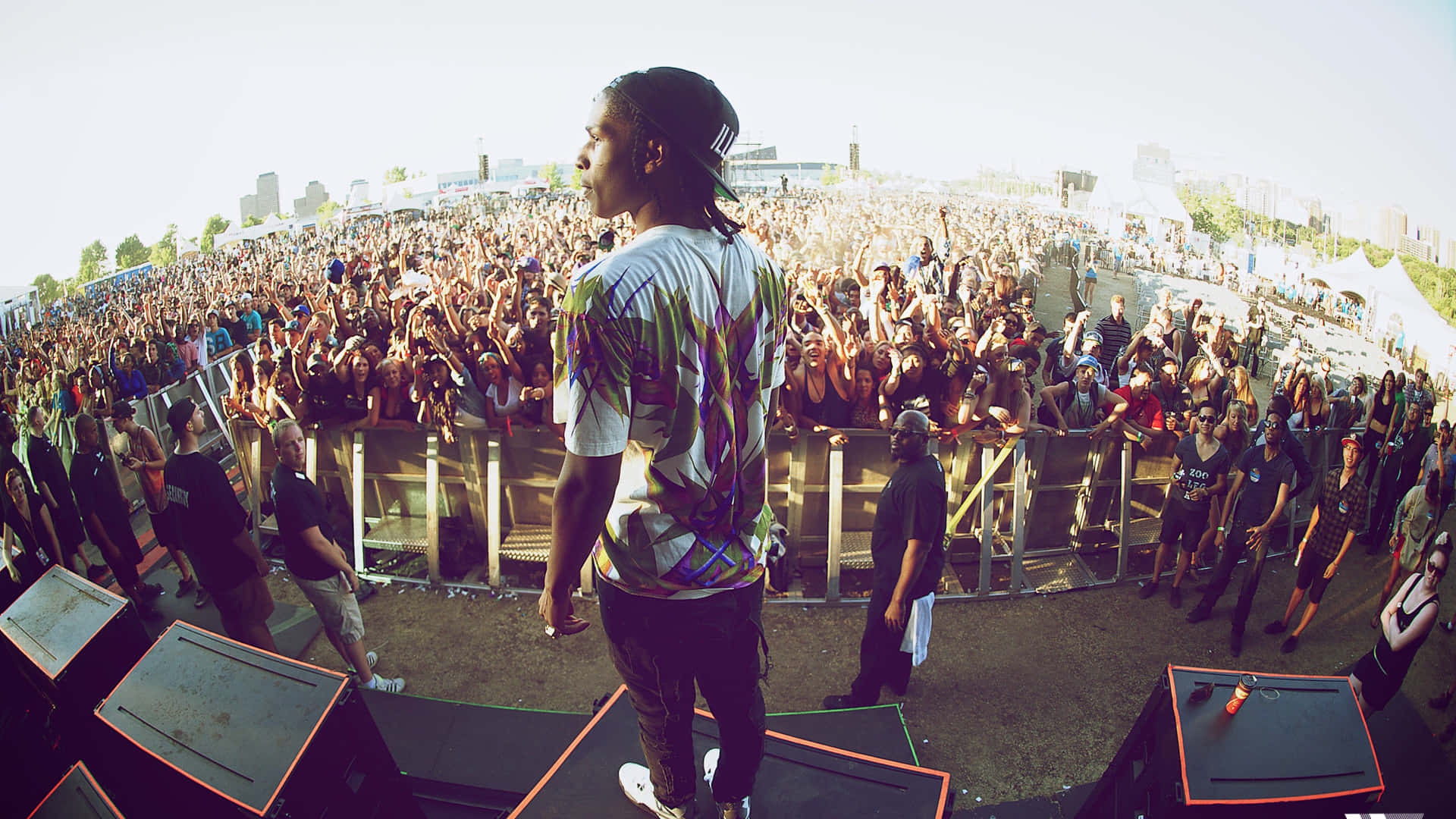 A Man Standing On Top Of A Stage In Front Of A Crowd Background