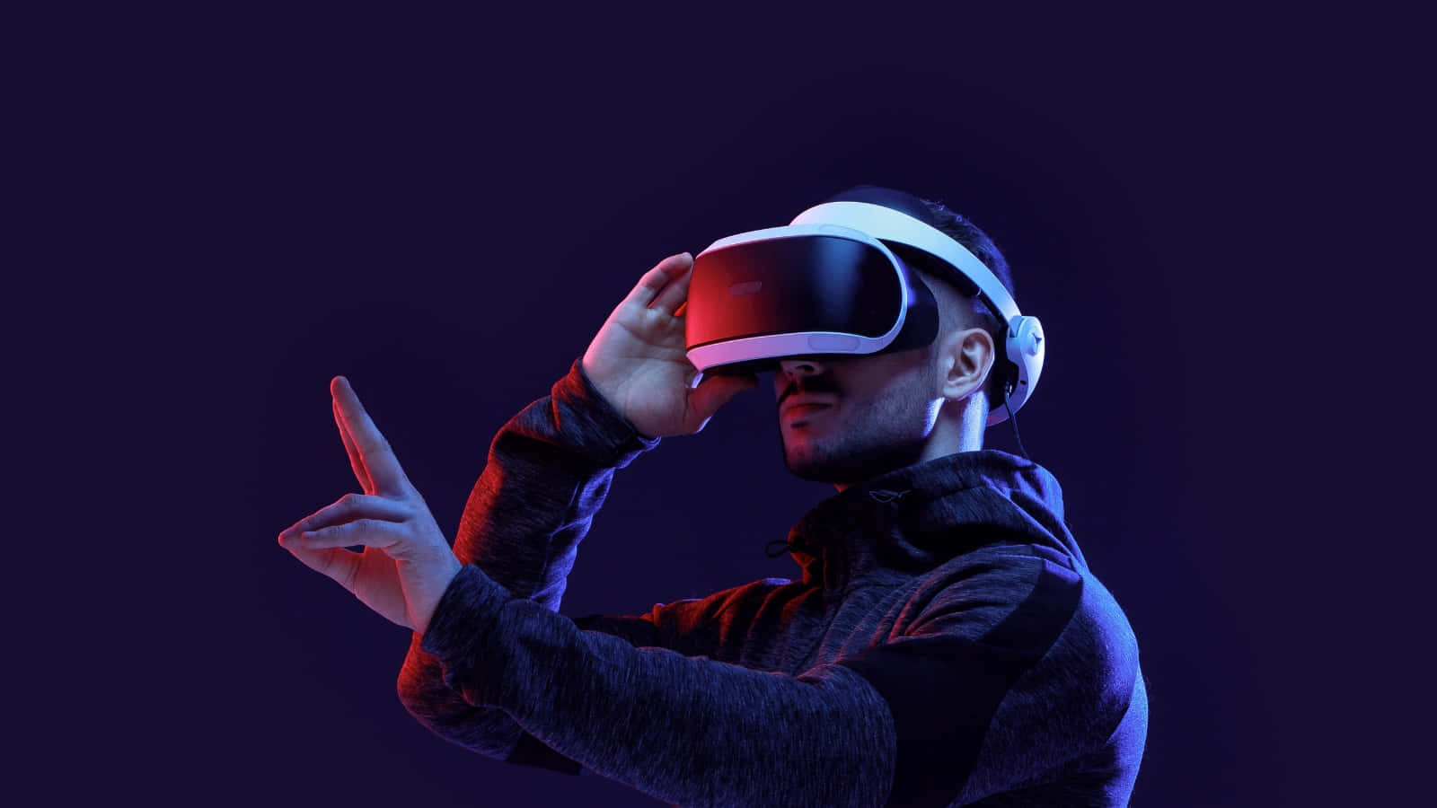 A Man Wearing A Virtual Reality Headset Background