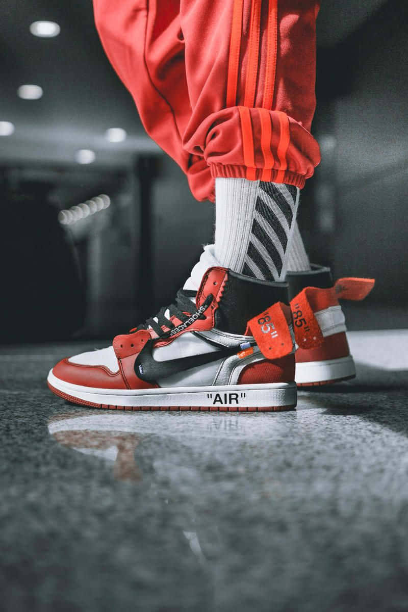 A Man Wearing Red And White Sneakers Background