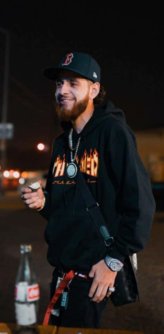 A Man With A Beard And A Hoodie Is Standing At Night Background