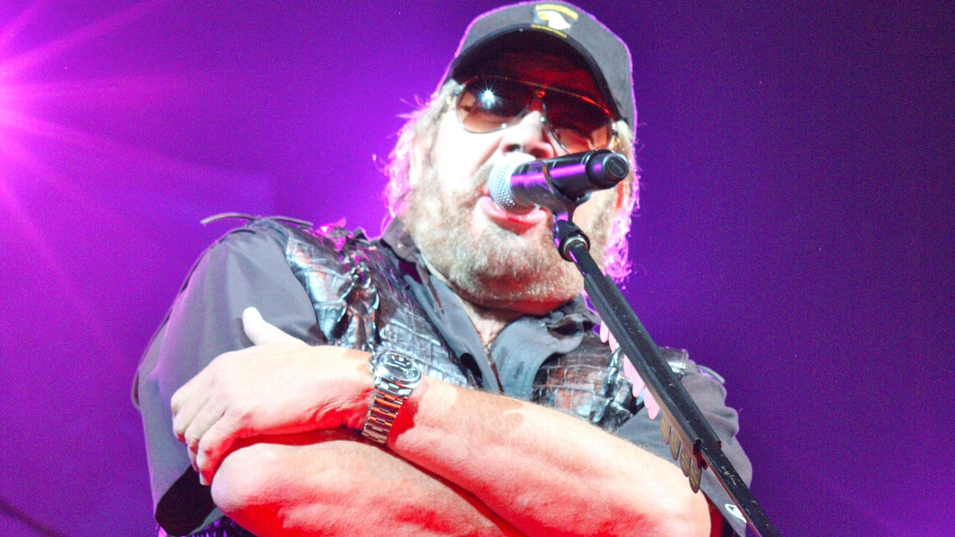 A Man With A Hat And A Microphone