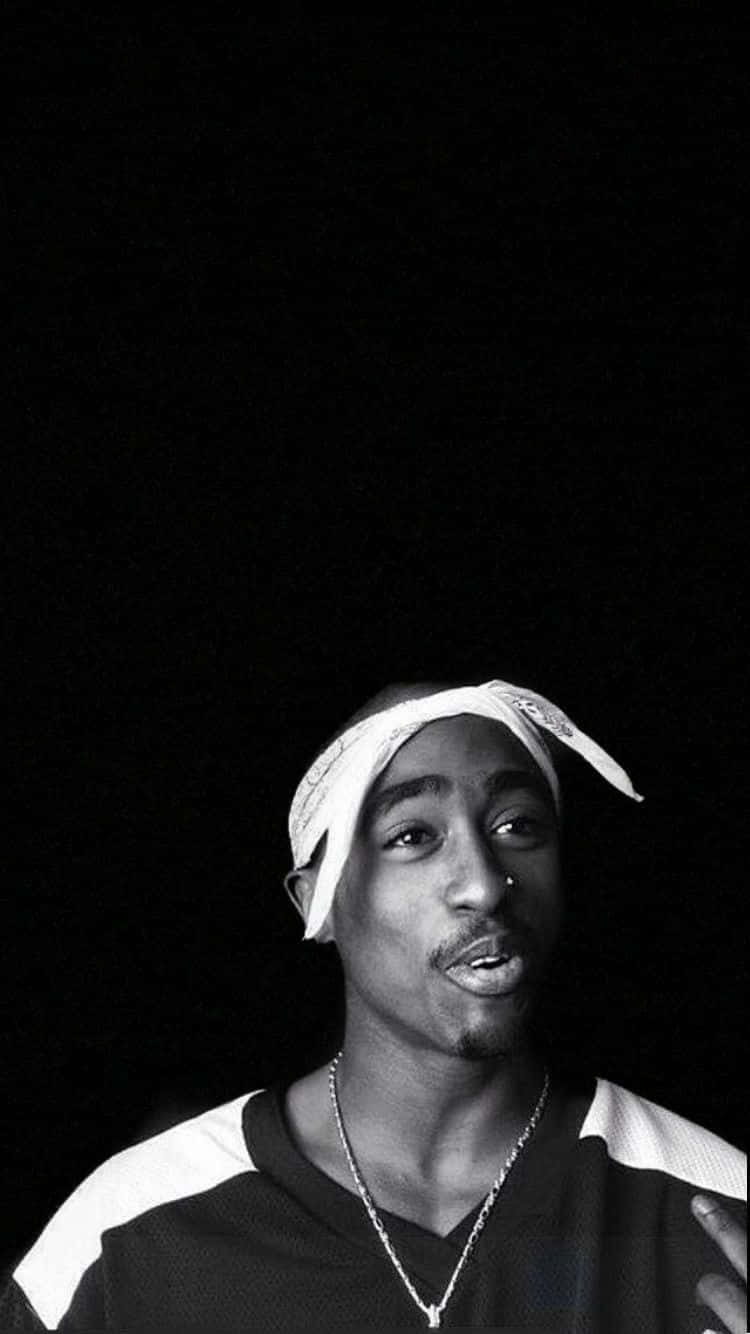 A Man With A Headband Is Standing In Front Of A Black Background Background