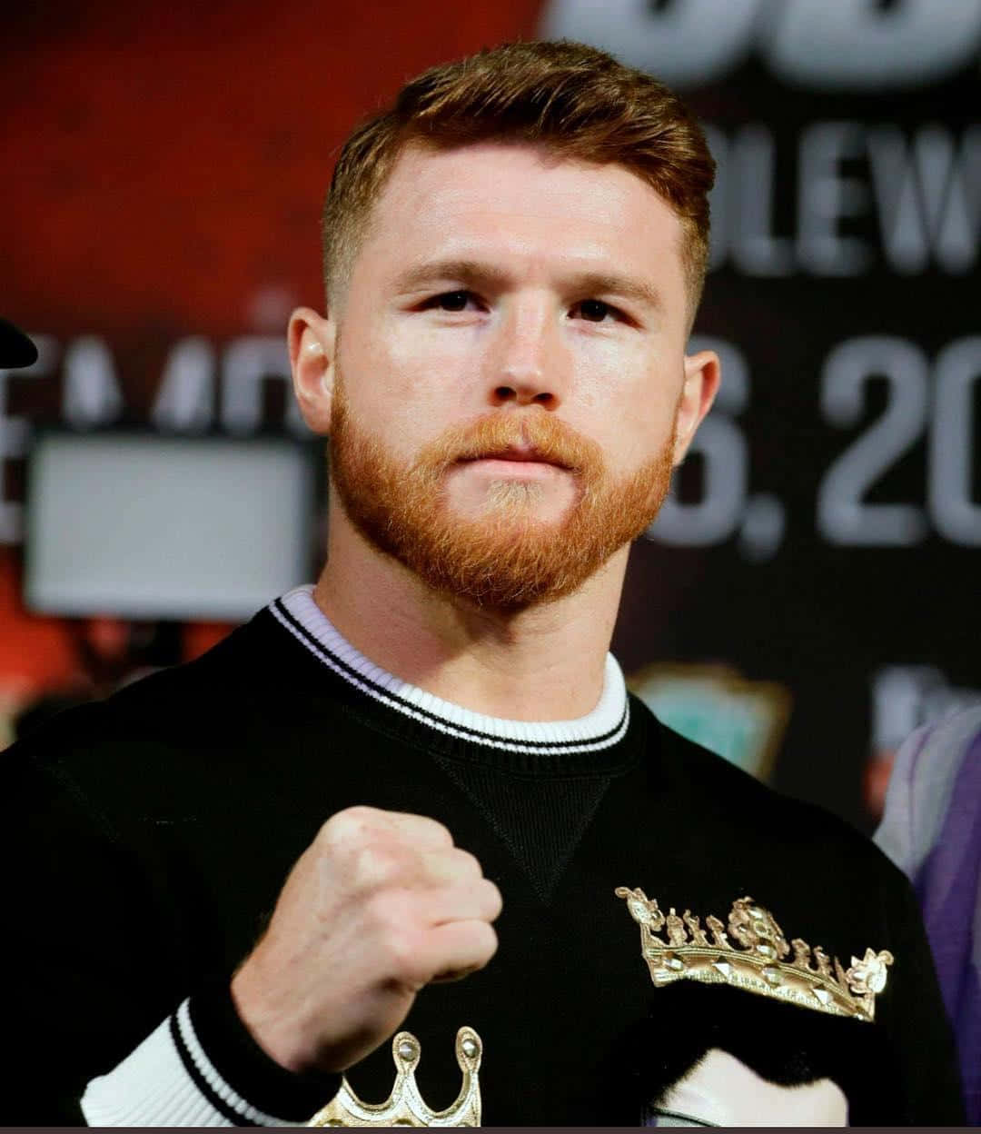 A Man With A Red Beard Is Standing Next To A Boxer Background