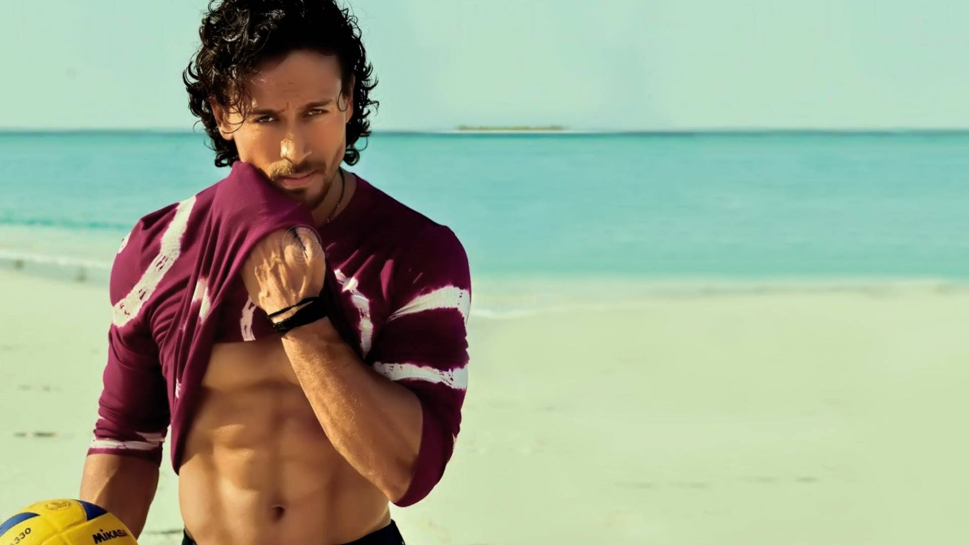 A Man With A Shirt And Shorts On The Beach Background