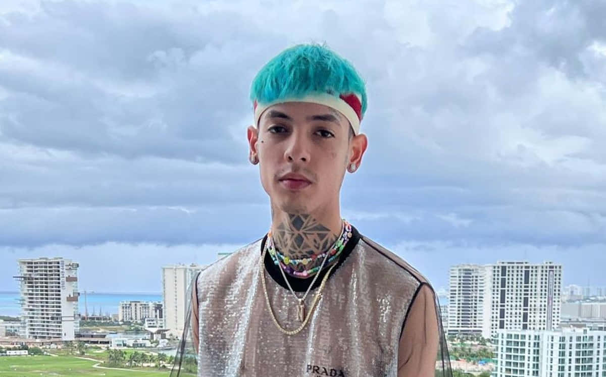 A Man With Blue Hair Standing In Front Of A Building Background