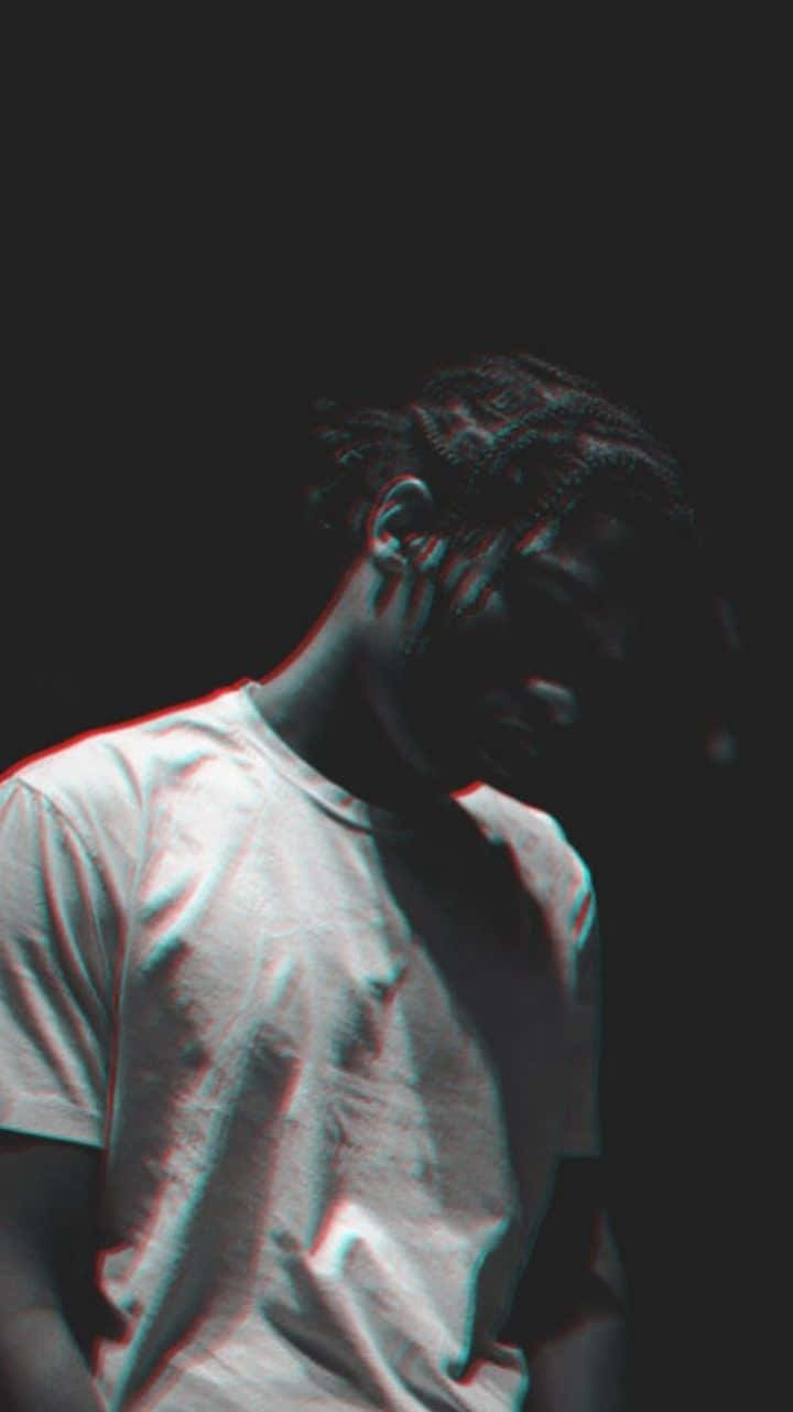 A Man With Dreadlocks Is Sitting On A Chair Background