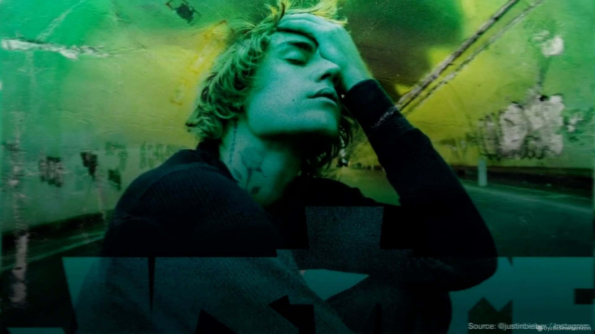 A Man With Green Hair Is Holding His Head Up Background