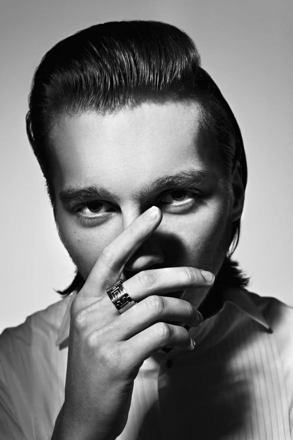 A Man With His Finger On His Nose Background