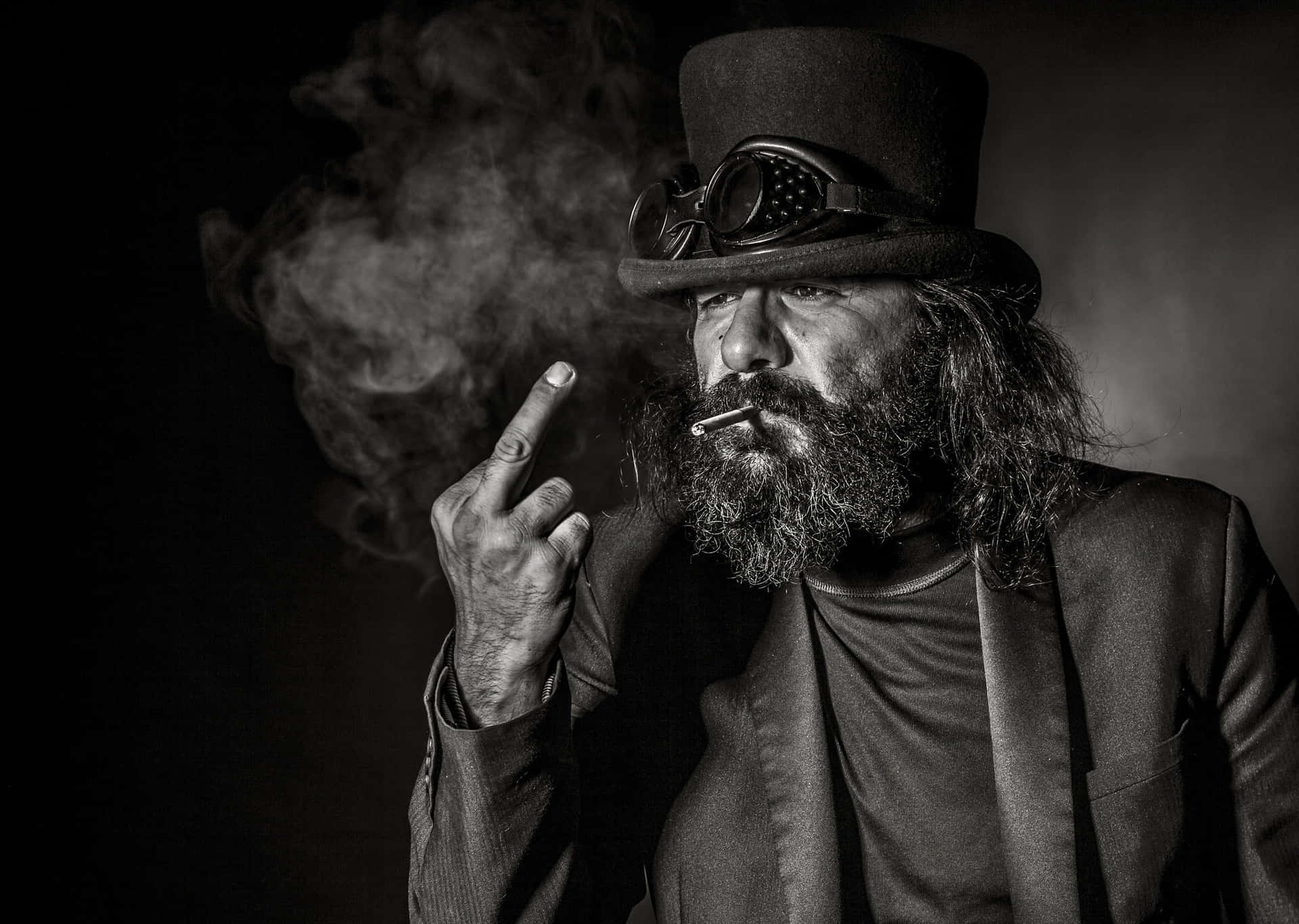 A Man With Long Hair And A Top Hat Smoking A Cigarette Background