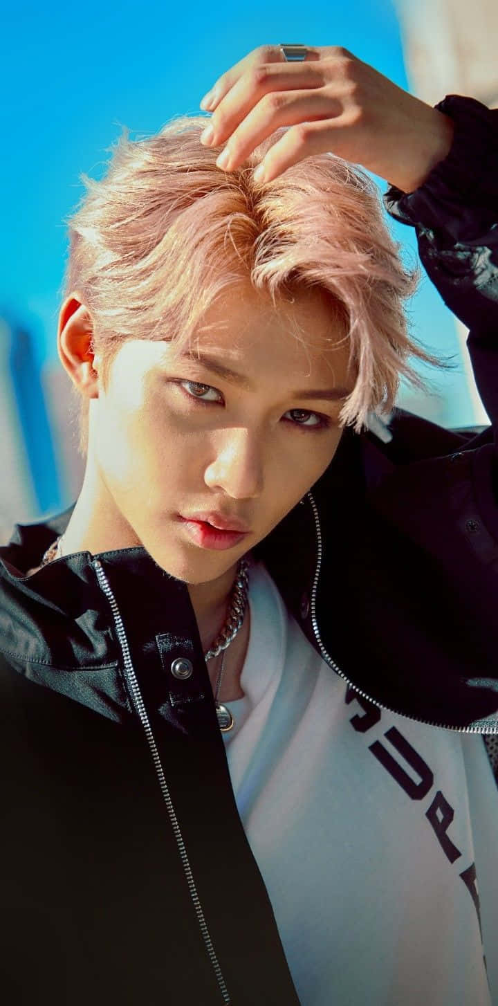A Man With Pink Hair Posing With His Head Down Background