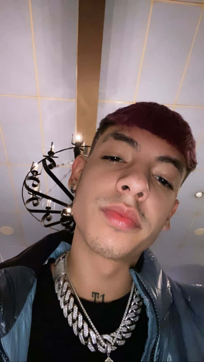 A Man With Red Hair And A Necklace Background