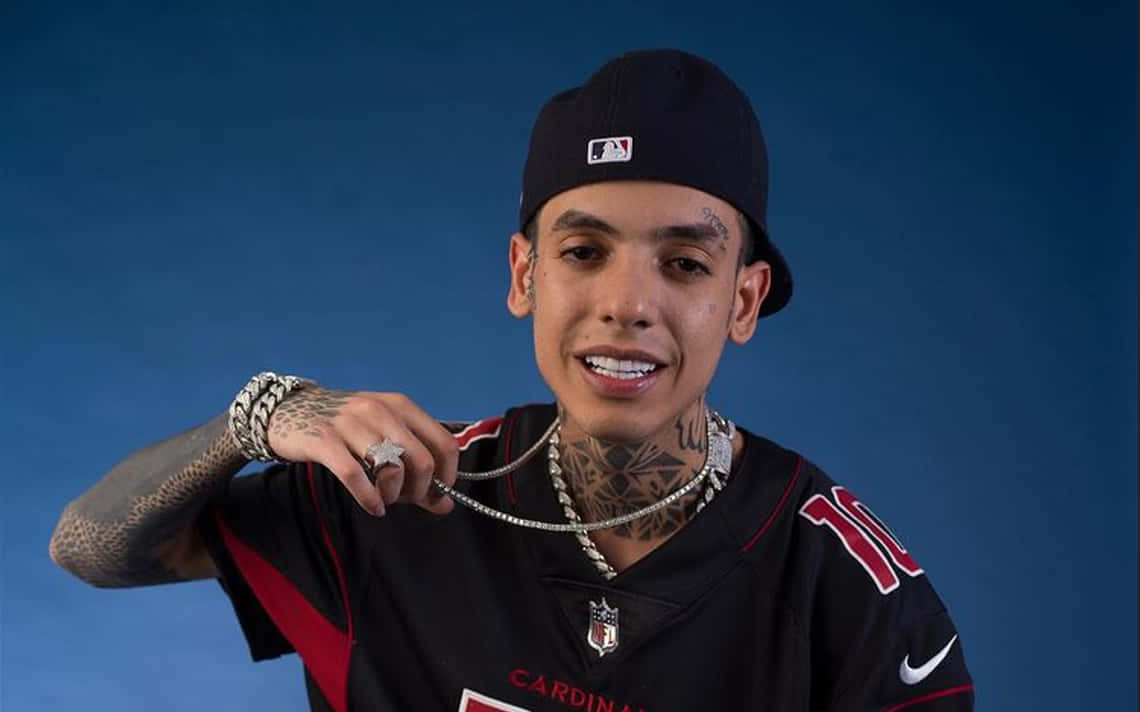 A Man With Tattoos And A Football Jersey Background