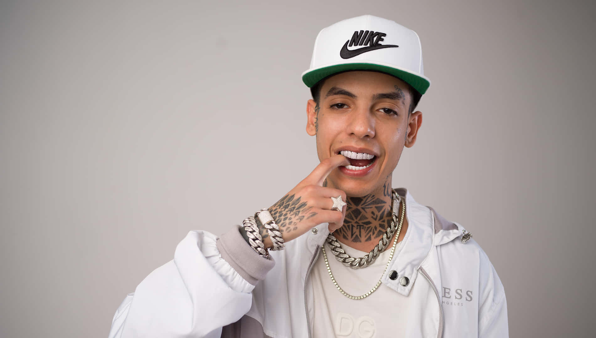 A Man With Tattoos And A Hat Is Posing For A Picture Background