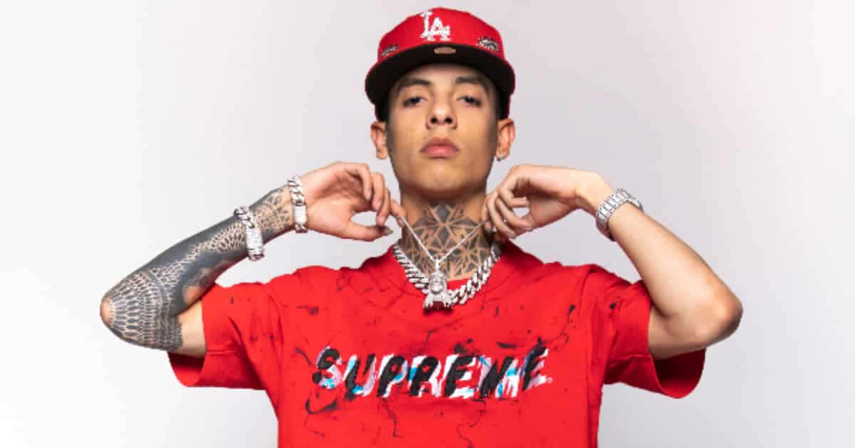 A Man With Tattoos And A Red Shirt Background