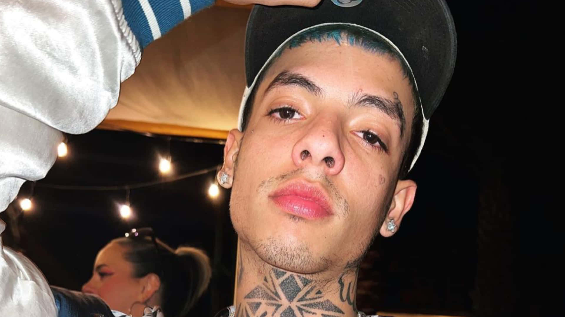 A Man With Tattoos On His Head Is Posing Background