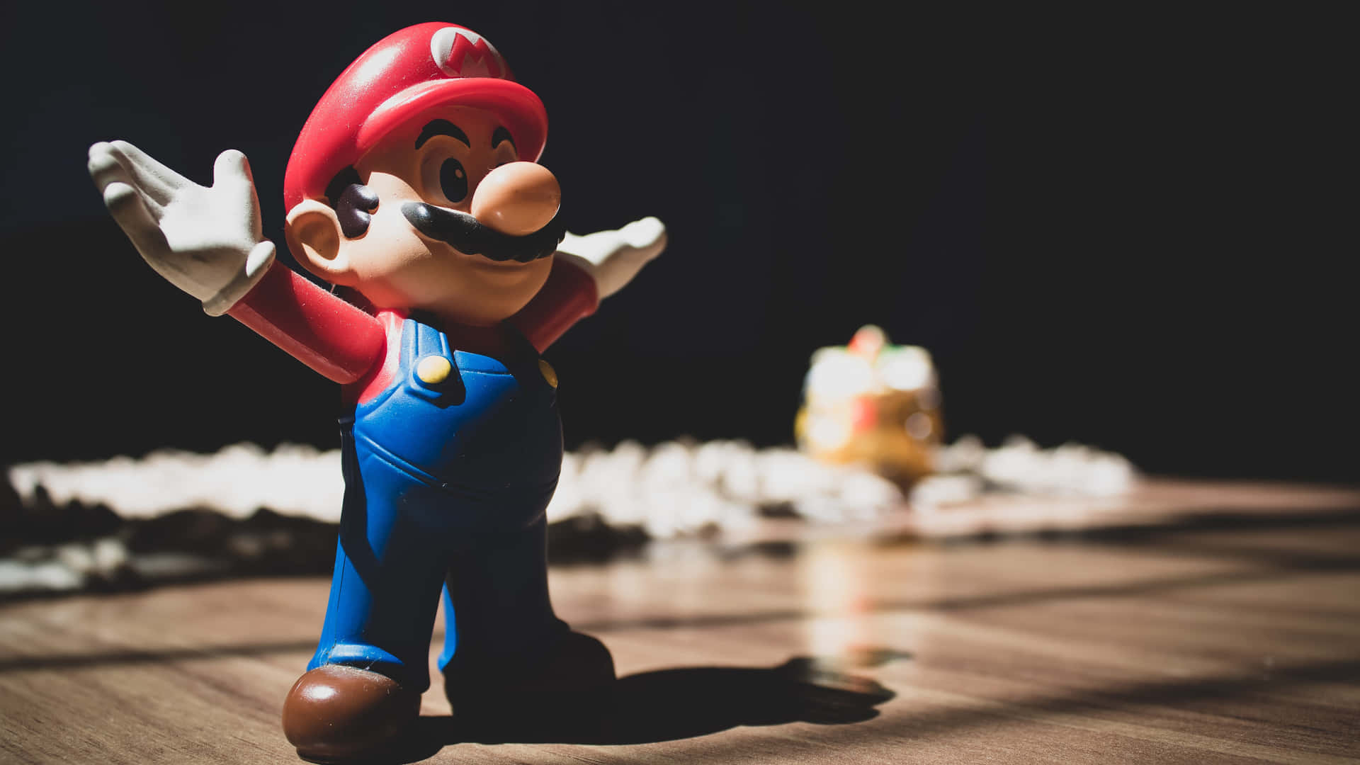 A Mario Figurine Is Standing In Front Of A Table Background