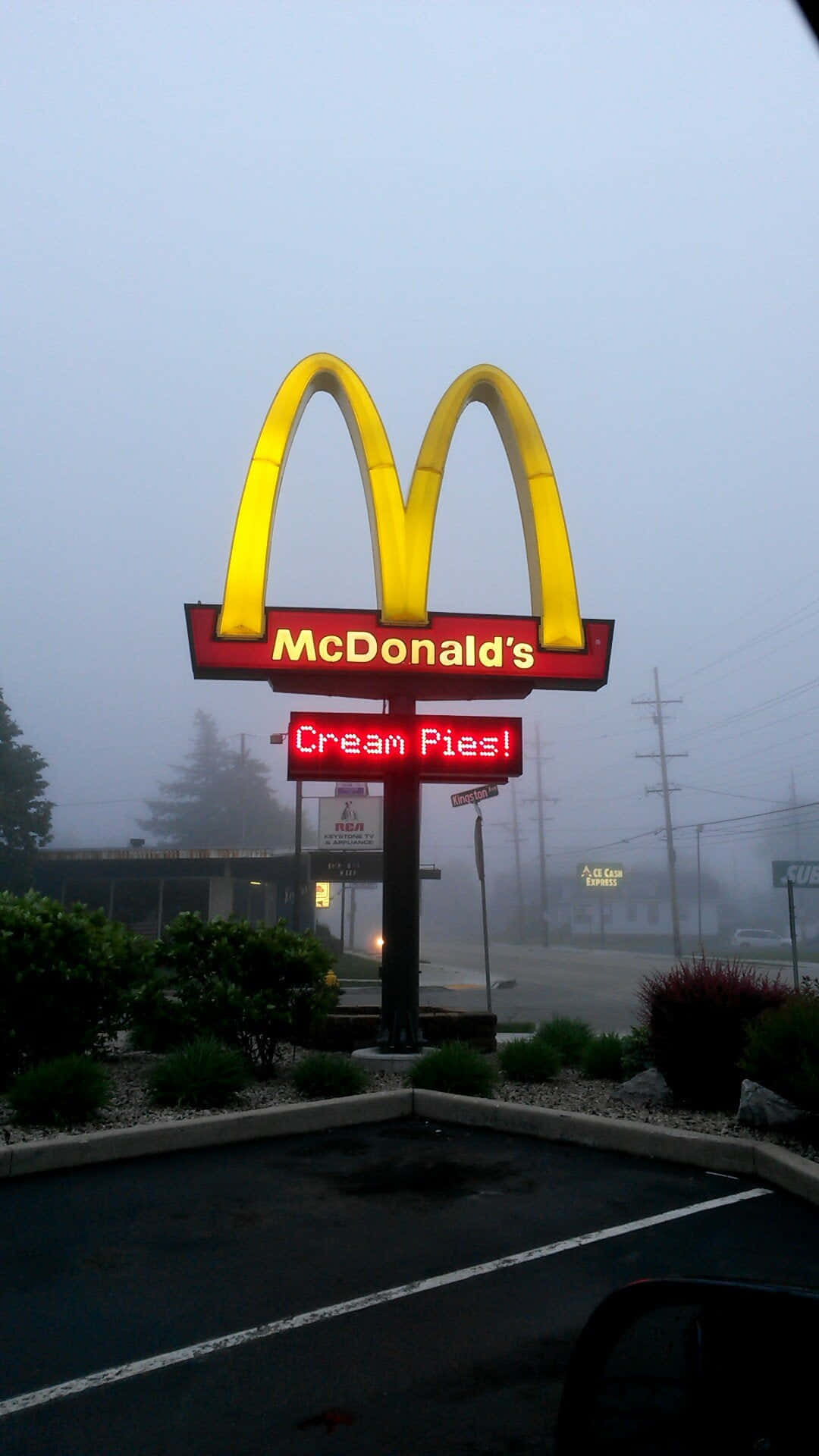 A Mcdonalds Sign In The Fog Background
