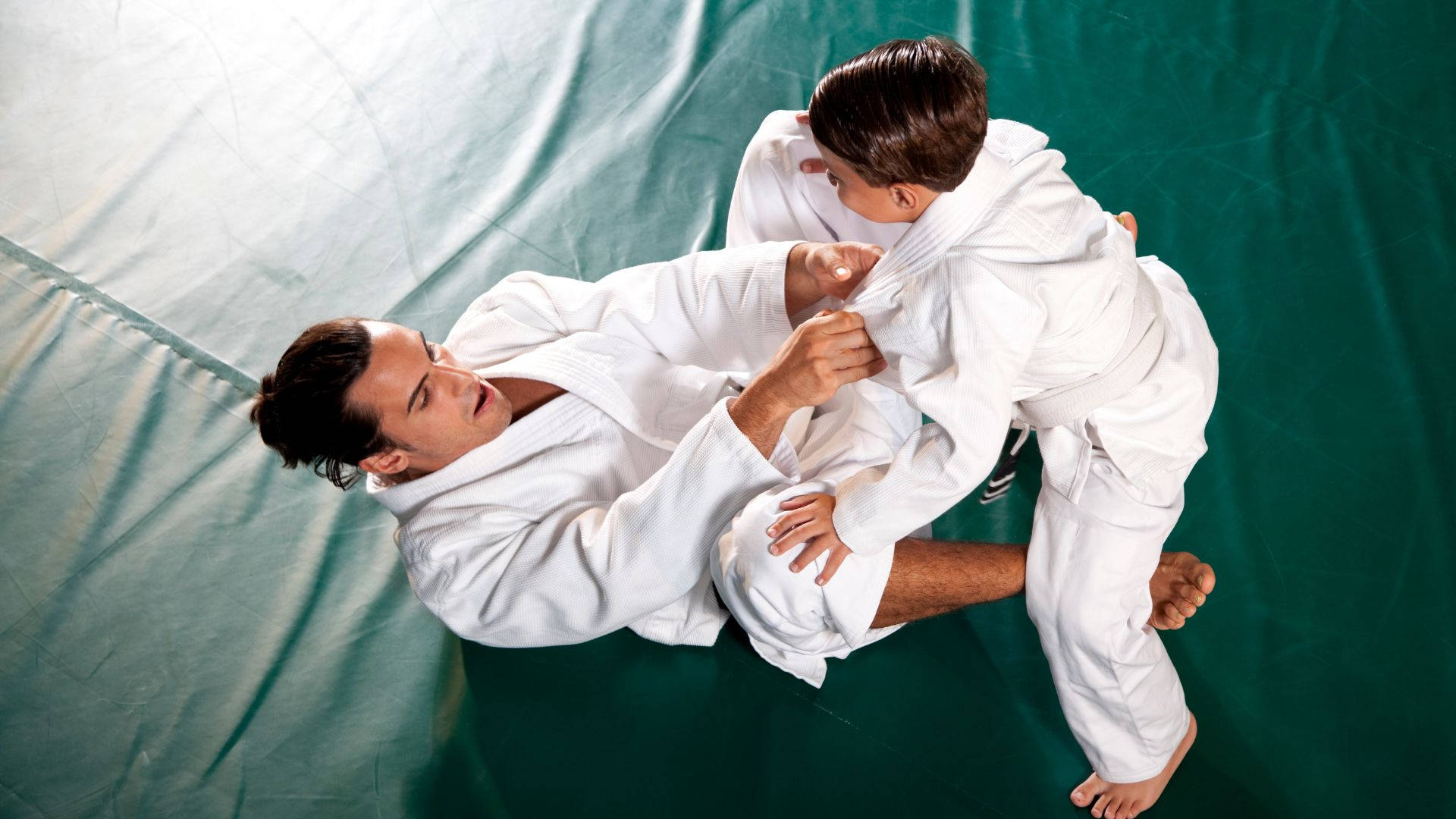 A Mentor Guiding A Young Talent In Brazilian Jiu-jitsu