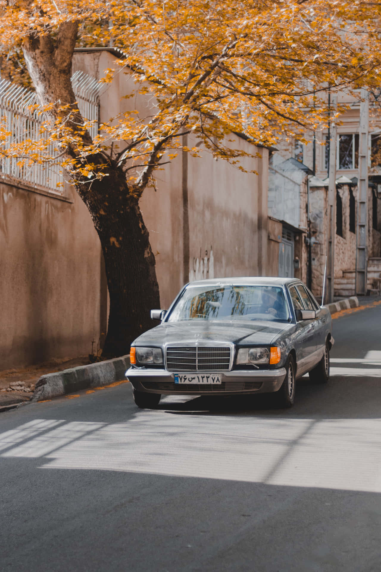 A Mercedes Benz Cls Parked On A Street Background