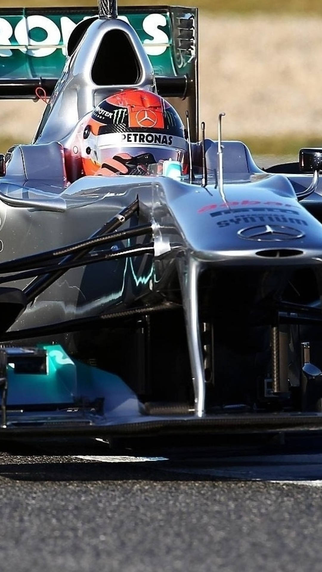 A Mercedes Racing Car Is Driving On A Track Background