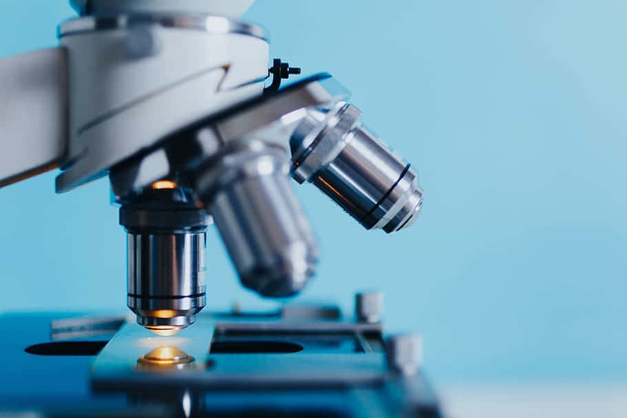 A Microscope Is Being Used To Look At A Sample Background