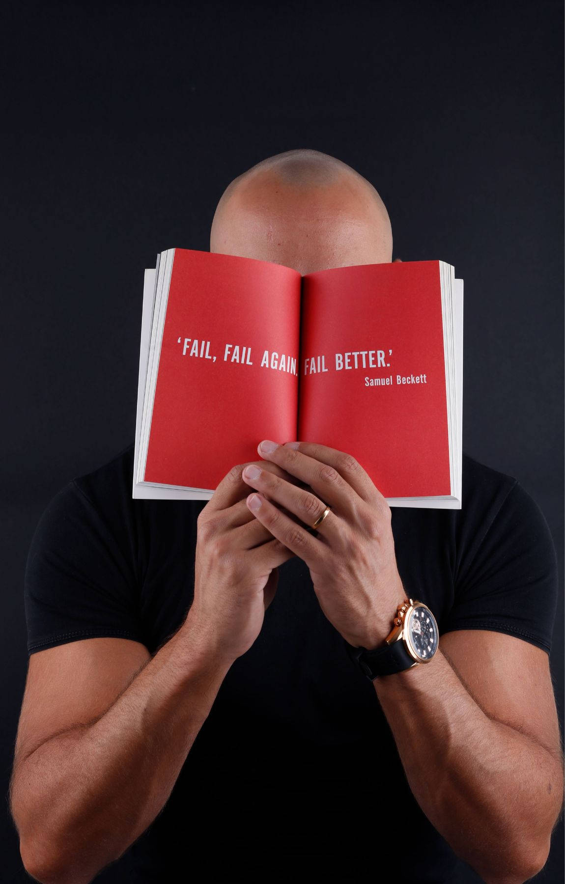 A Middle Aged Bald Man Covering His Face With His Hands Background