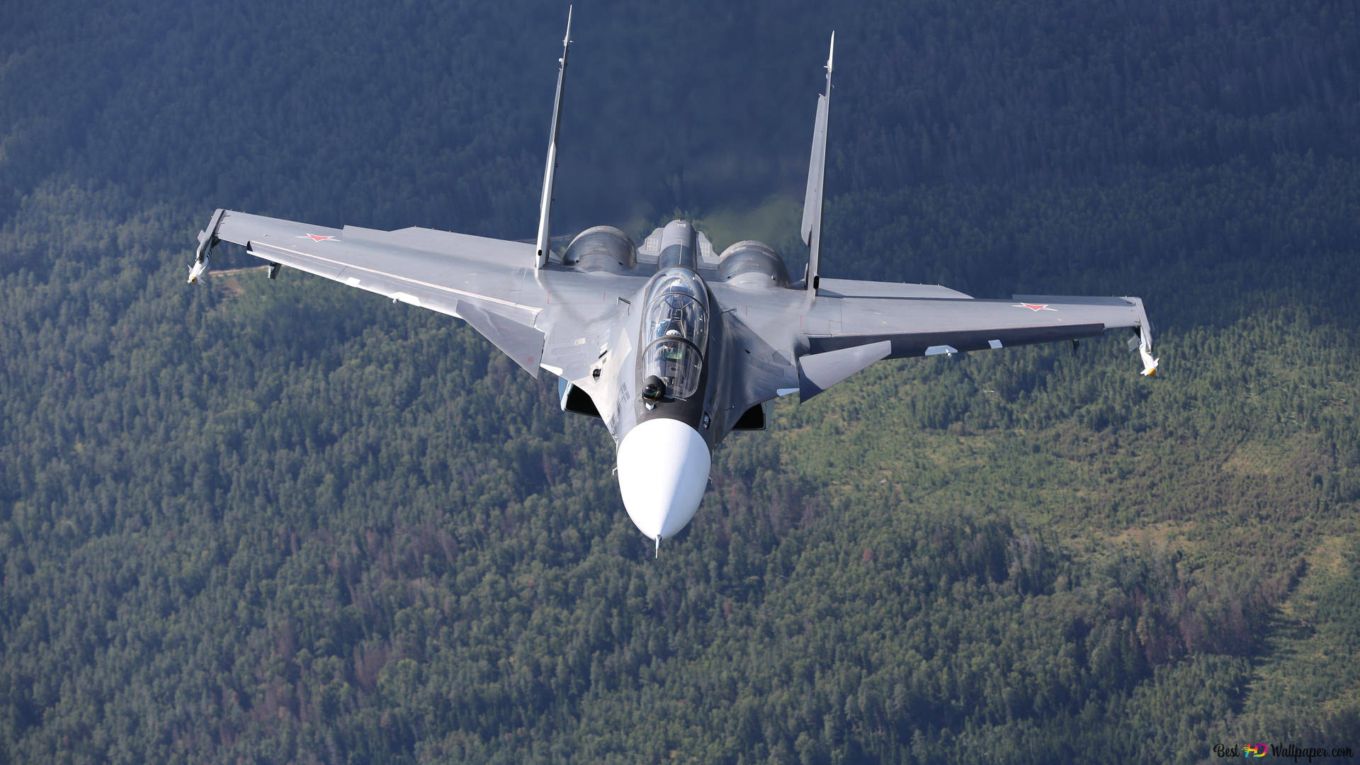 A Military F/a-18 Hornet Fighter Plane Flying In The Skies Background