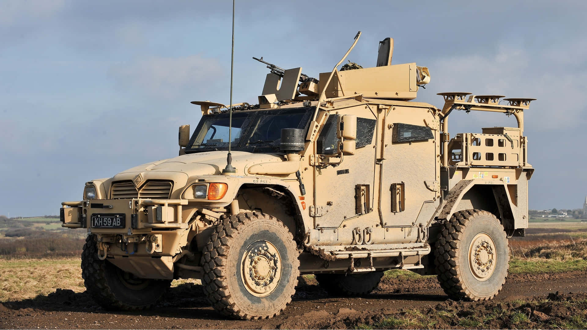 A Military Vehicle Is Driving Down A Dirt Road Background