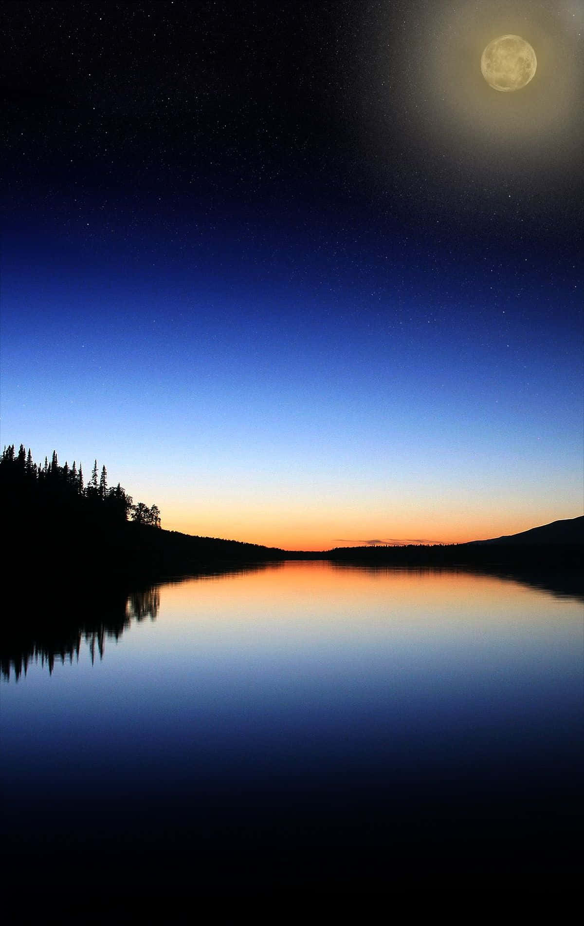 A Moon Is Reflected In A Lake At Night