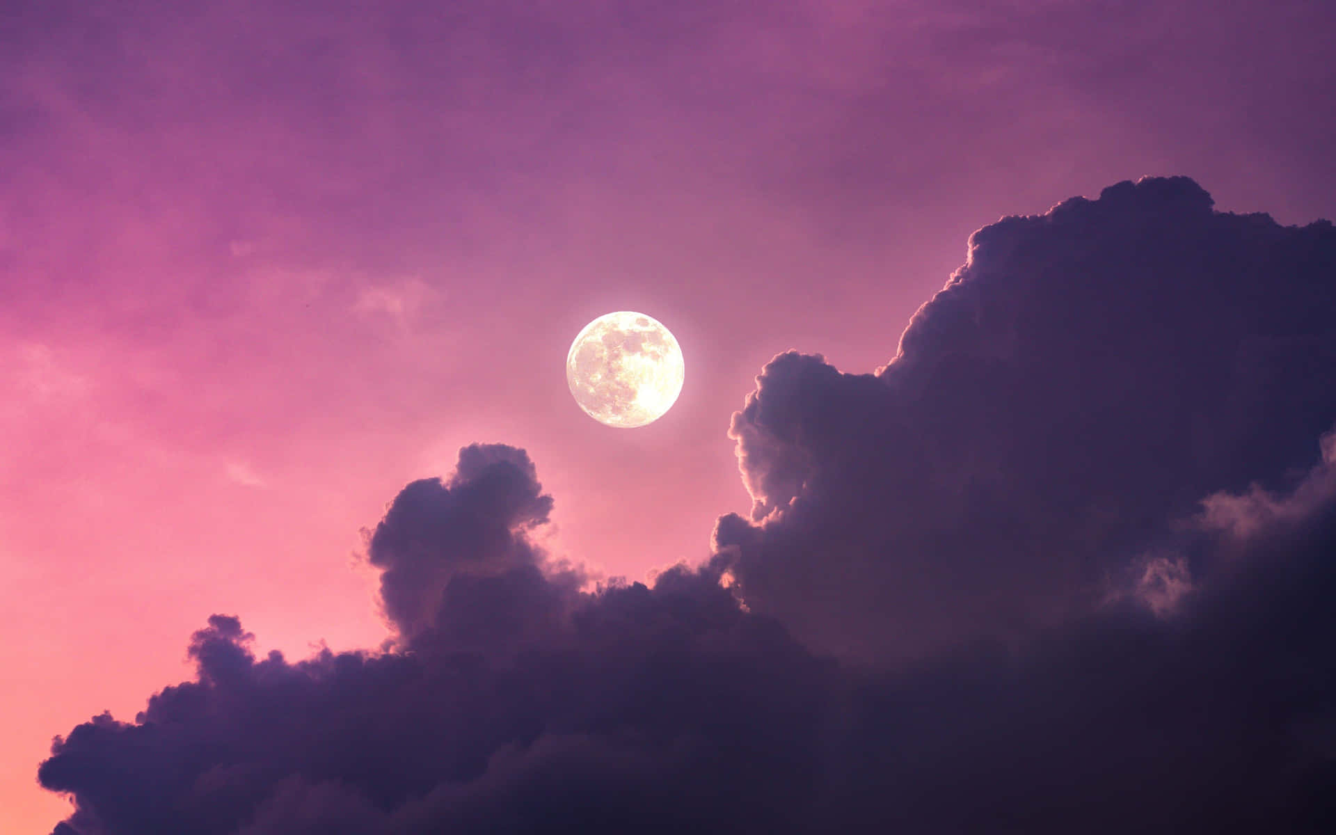 A Moon Is Seen Through A Purple Cloudy Sky Background