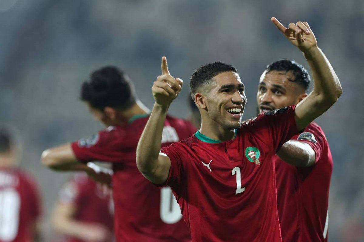 A Moroccan National Football Team Player Celebrating With A Point Towards The Sky Background