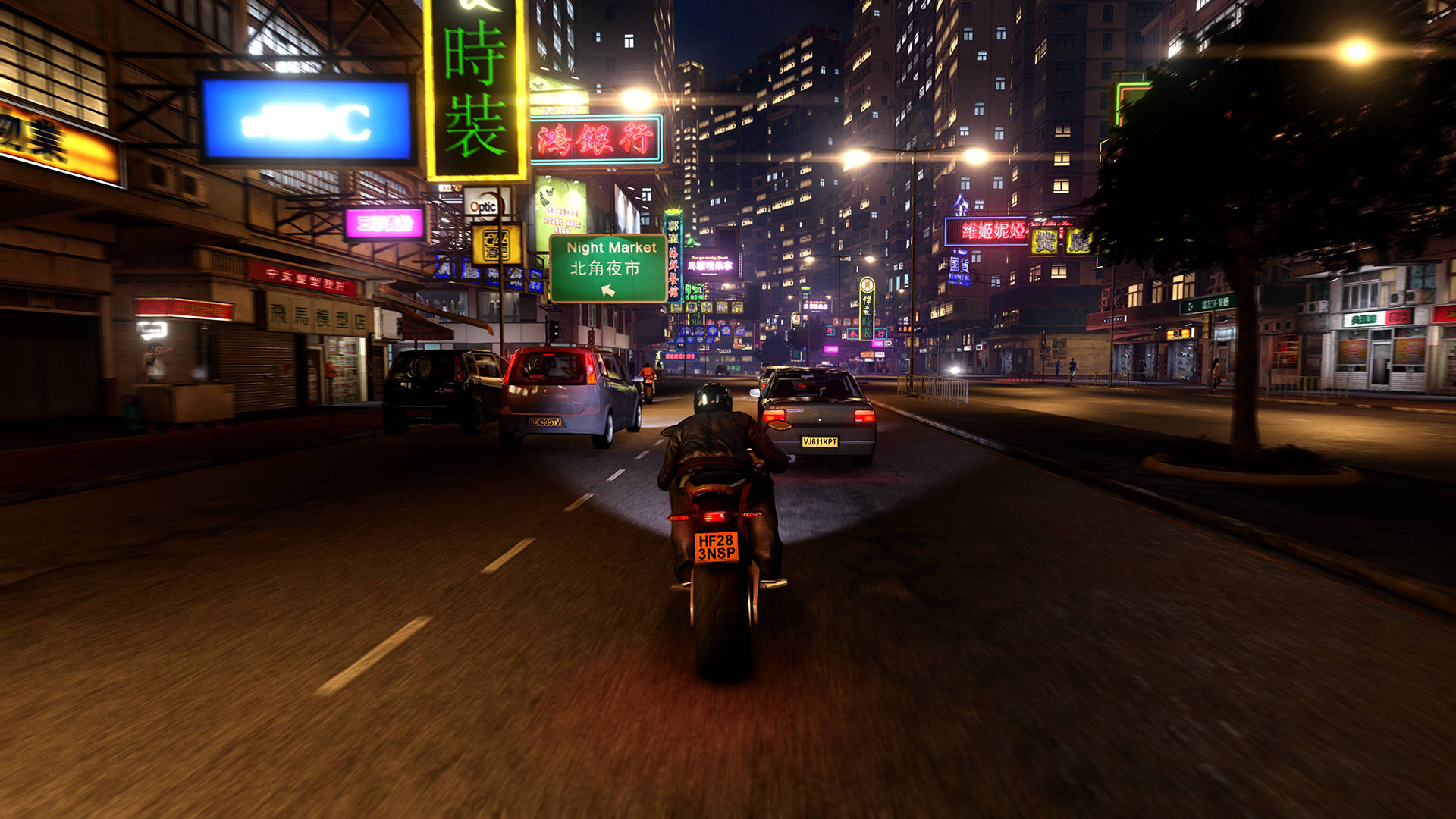 A Motorcycle Is Driving Down A City Street Background