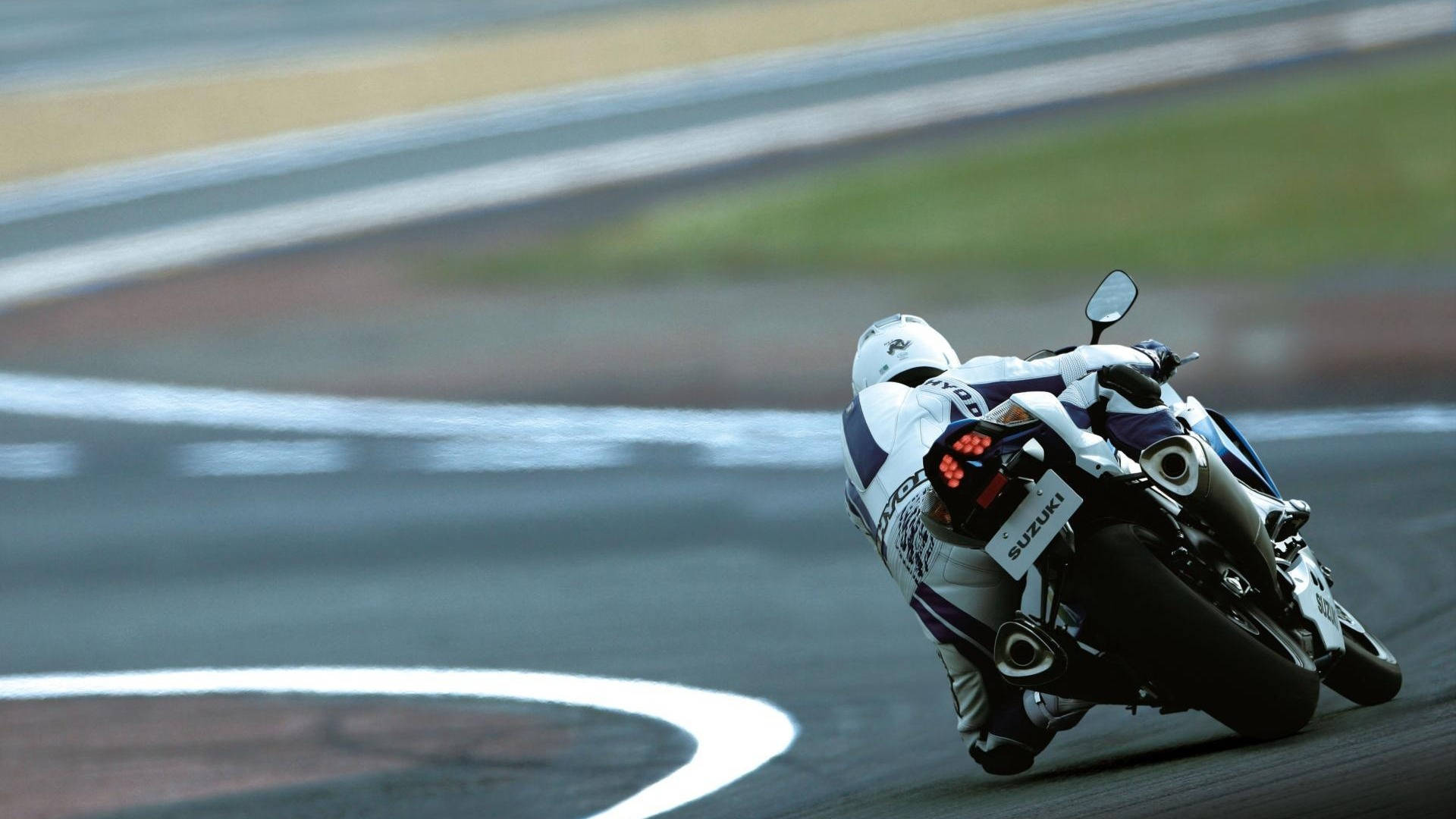 A Motorcycle Is On A Track Background