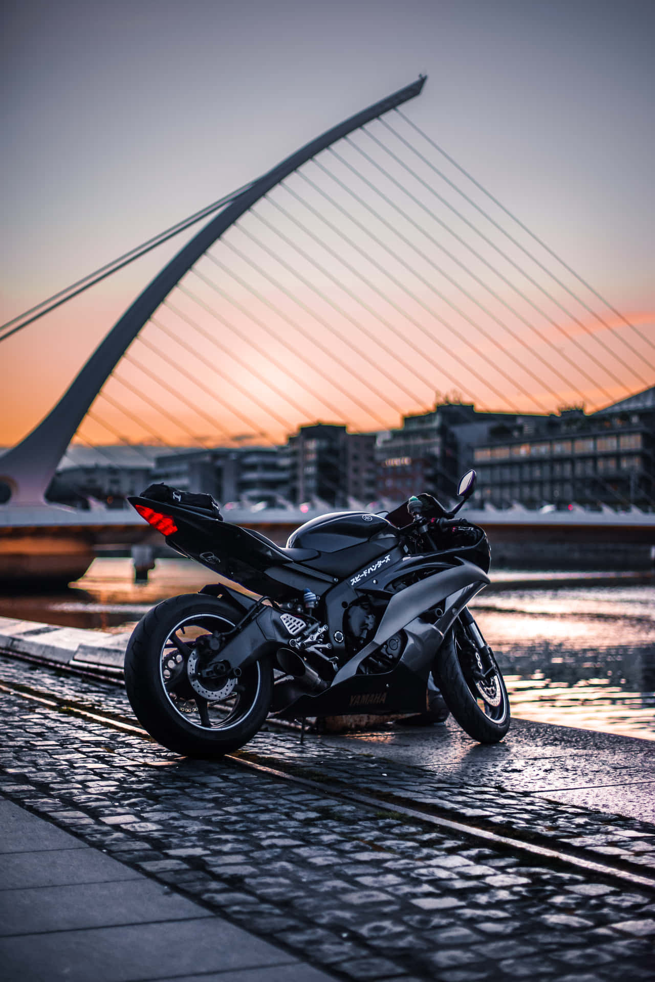 A Motorcycle Parked On The Sidewalk Background