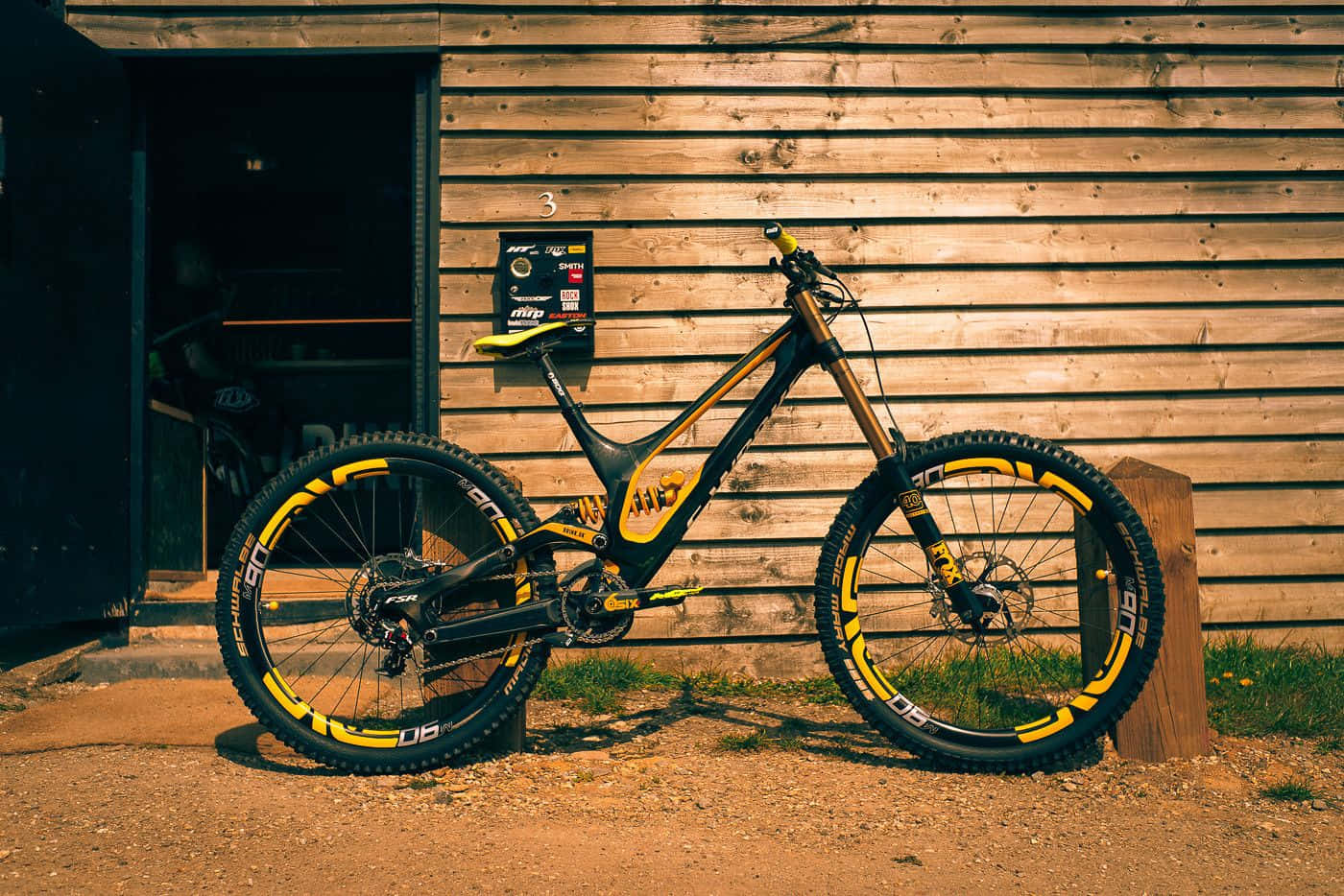 A Mountain Bike Leaning Against A Building Background