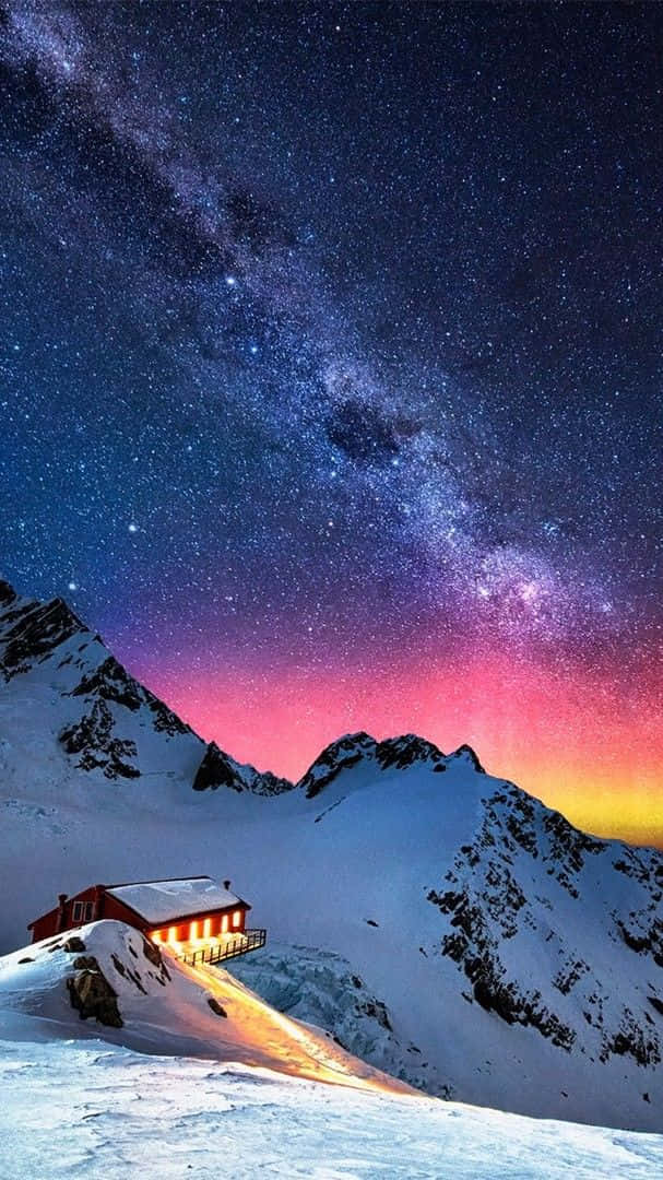 A Mountain Cabin With A Milky Above It Background