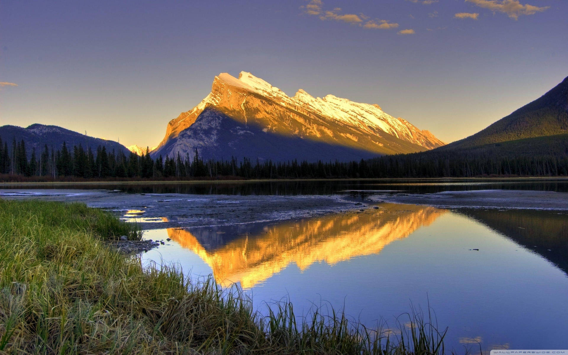 A Mountain Is Reflected In A Lake Background