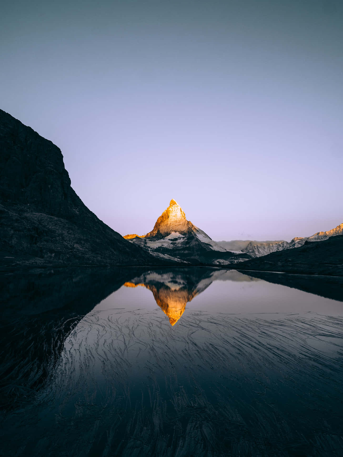 A Mountain Is Reflected In The Water Background