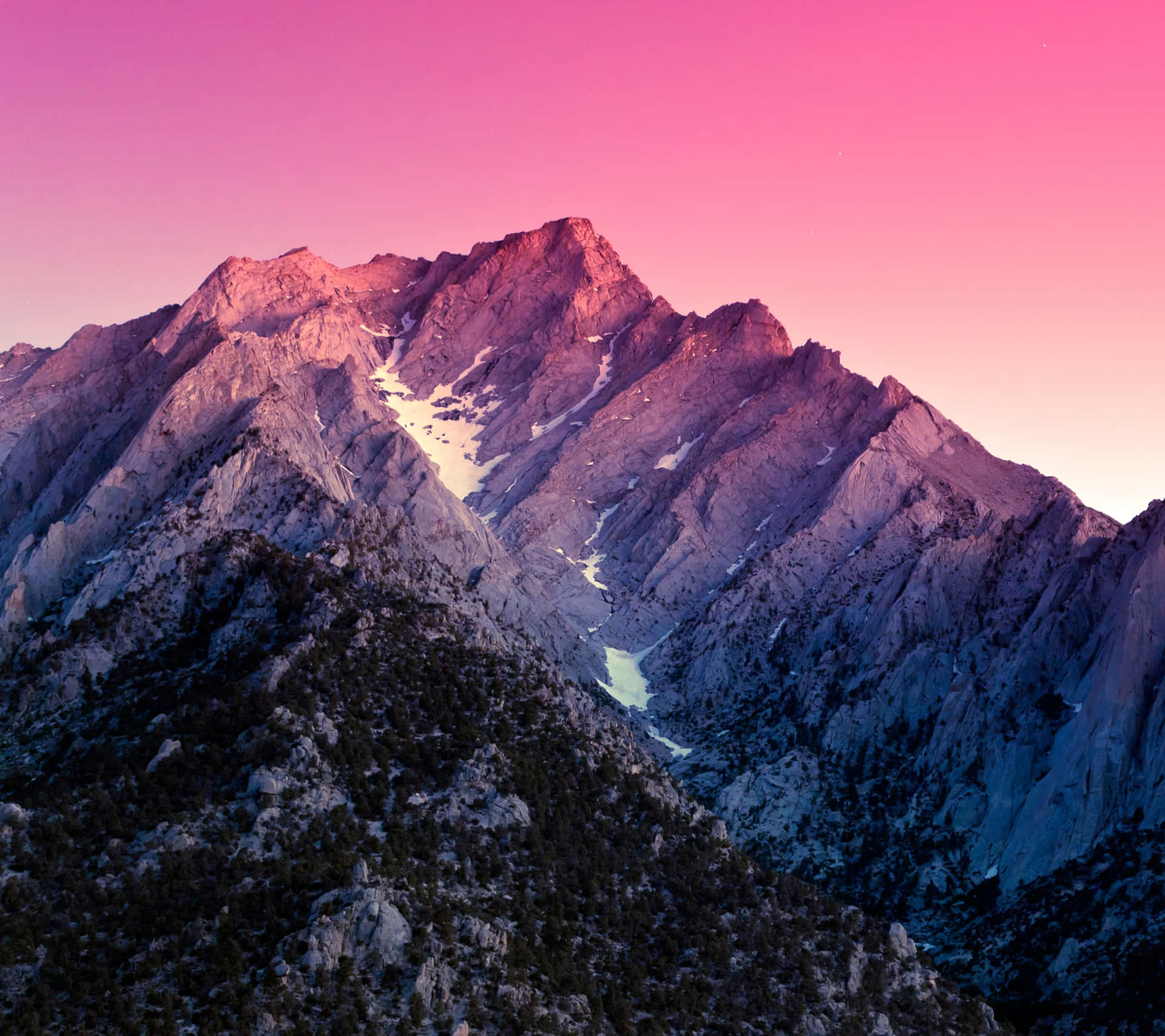 A Mountain Range With A Pink Sky And Snow Background