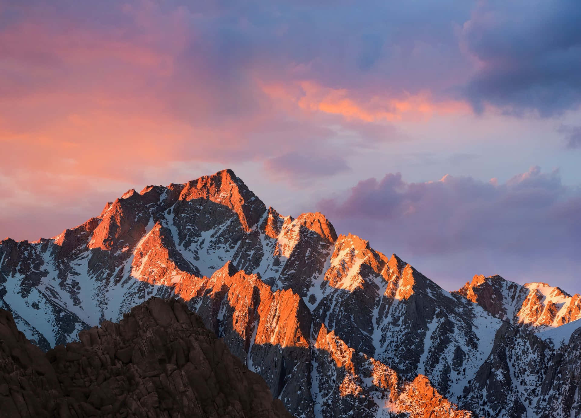 A Mountain Range With A Sunset In The Background Background